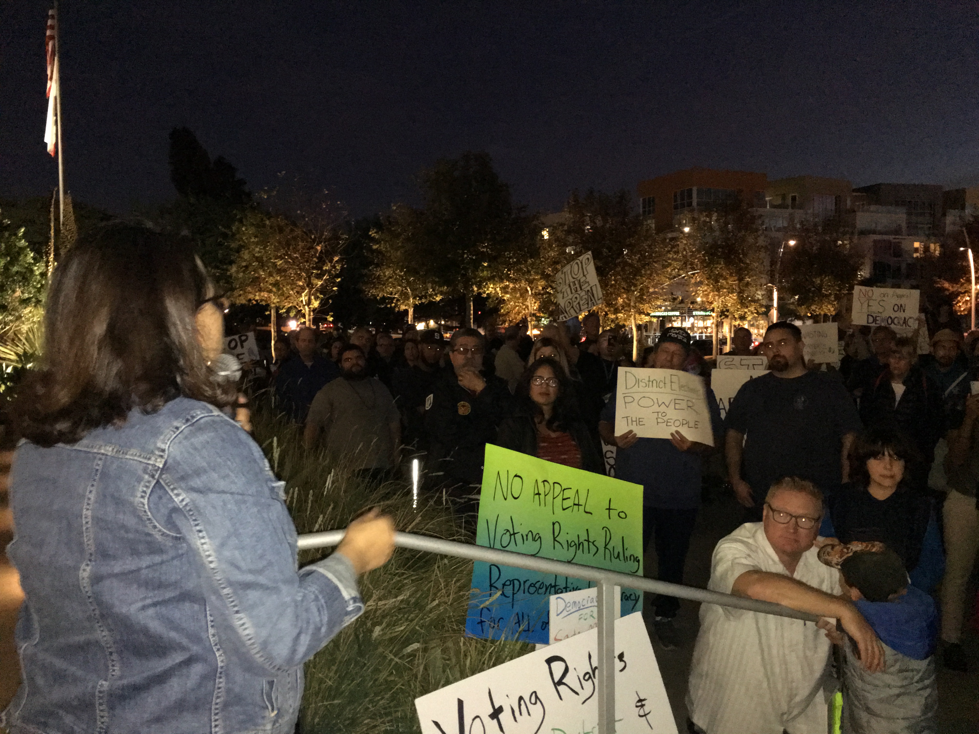 Voting rights plaintiff Maria Loya addresses crowd in front of City Hall
